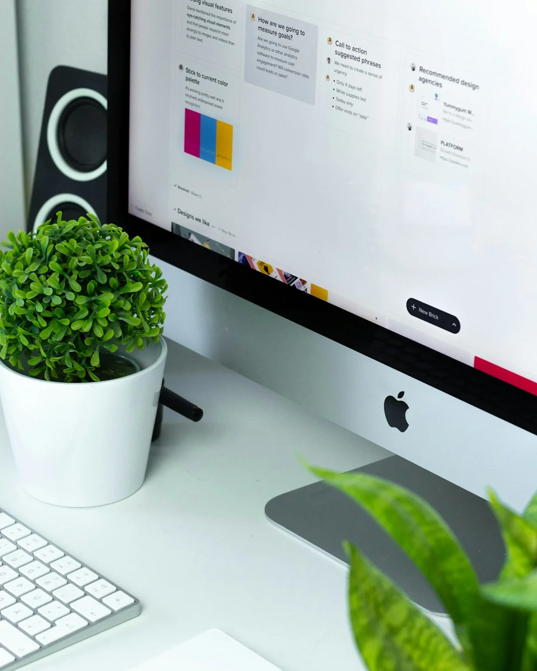 A clean and organized home office desk with a cleaner bottle and sponge, emphasizing simplicity and functionality.